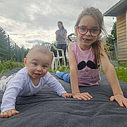 Liana a rejoint le concours — aidez-le/la à gagner de superbes lots ! baby, child, girl, glasses, outdoor, grass, mat, smile, happy, person, woman, fence, garden, shirt, casual, nature, daylight, playing, family, lawn