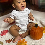 Joseph joined the competition — help win amazing prizes! baby, babylaughing, bodypart, diaper, face, finger, food, hand, happy, head, leaf, person, photography, plant, portrait, produce, pumpkin, sitting, squash, vegetable