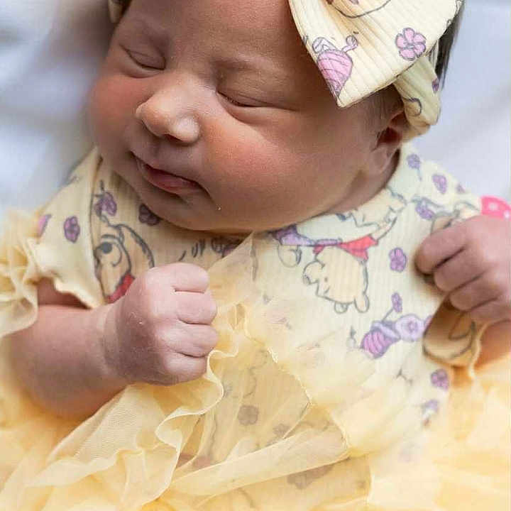 Iris joined the competition — help win amazing prizes! adorable, baby, bow, child, closeup, clothing, cute, dress, fabric, fist, headband, indoor, infant, newborn, peaceful, portrait, skin, sleeping, soft, yellow
