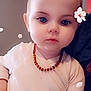 baby, child, face, portrait, indoor, necklace, white_clothing, flower_effect, closeup, serious_expression, cute, young_child, skin, head, small_person, infant, human, soft_light, beads, decorative