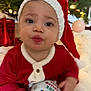 Lucas joined the competition — help win amazing prizes! baby, child, christmas_tree, christmas_ornament, santa_hat, holiday, festive_clothing, red_clothing, knit_hat, holiday_decorations, twinkling_lights, indoor, cute, smiling, holiday_season, festive, christmas, holiday_spirit, decor, celebration