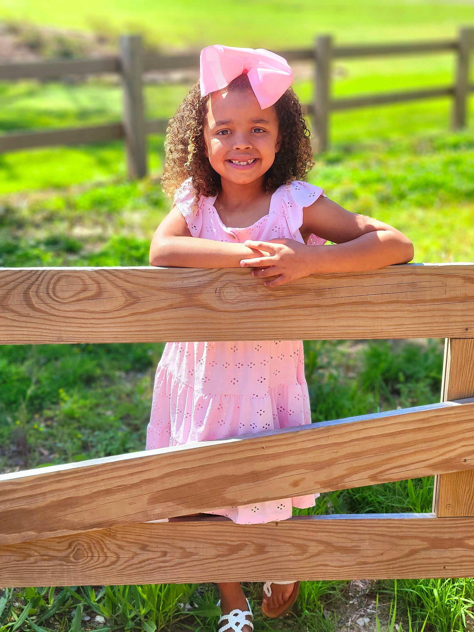 Malaya is registered to the contest to win money with this photo: child, dress, face, fun, grass, green, happy, hat, headwear, joy, leisure, magenta, outdoor_furniture, people_in_nature, person, plant, recreation, sitting, smile, spring