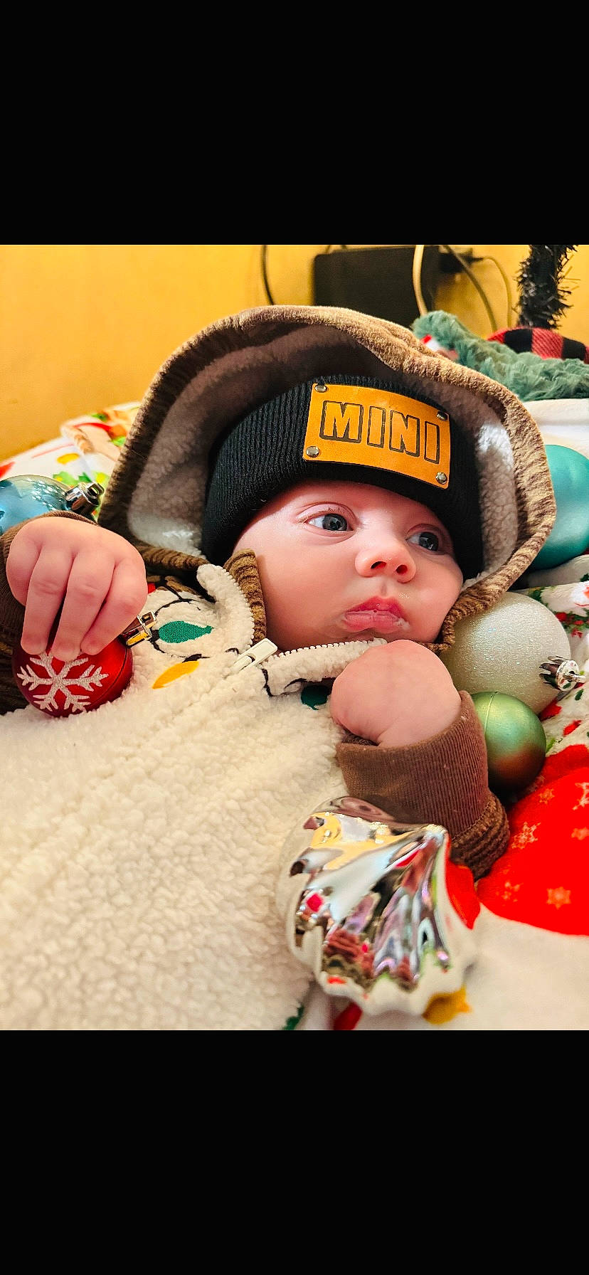 Paxton is registered to the contest to win money with this photo: baby, baby_sleeping, beanie, cap, child, comfort, event, facial_expression, fashion_accessory, fun, happy, headgear, headwear, knit_cap, leisure, linens, nail, person, skin, toddler