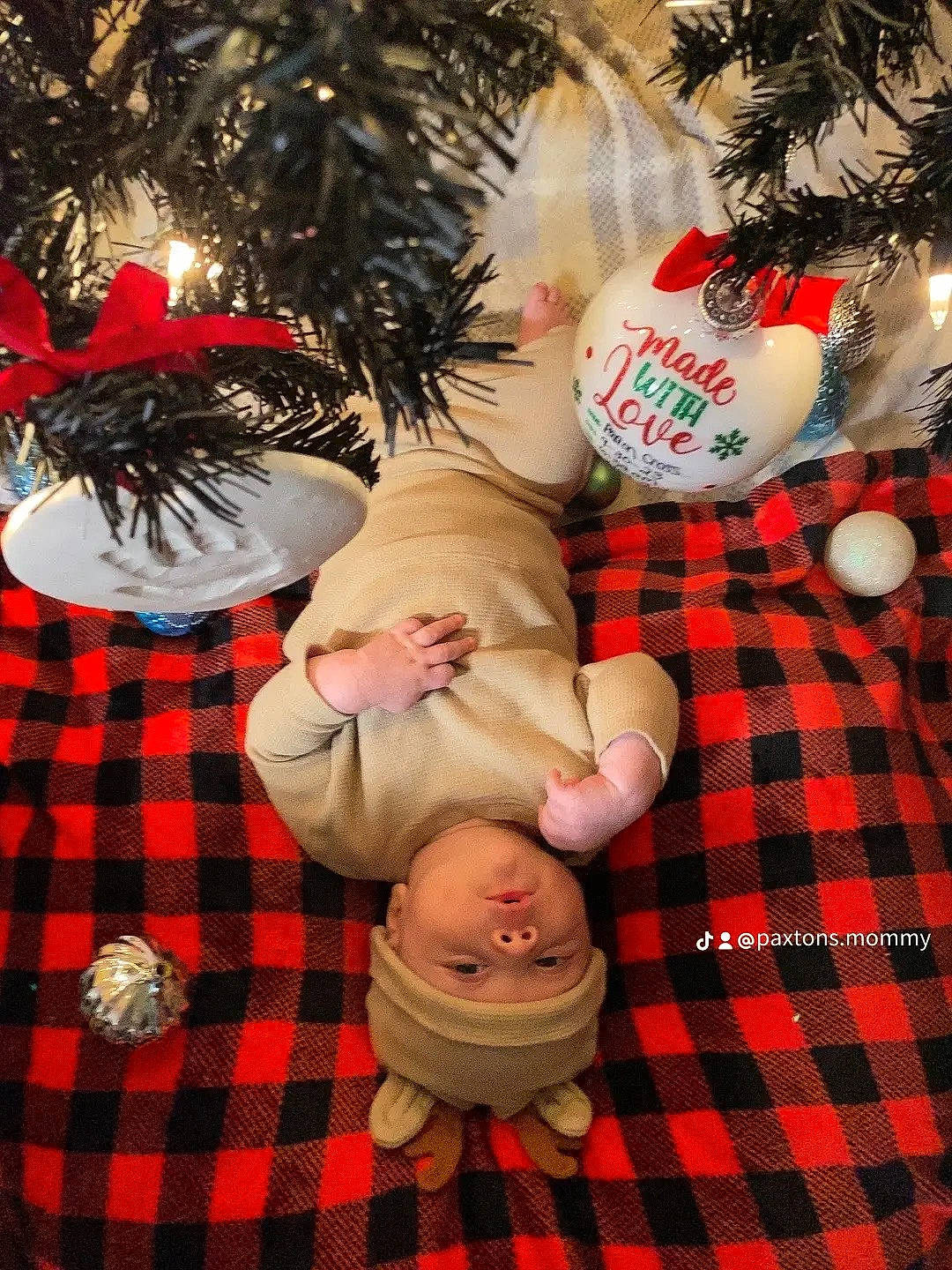 Paxton joined the competition — help win amazing prizes! baby, baby_toddler_clothing, child, christmas, christmas_decoration, christmas_eve, christmas_ornament, christmas_tree, event, happy, head, headwear, holiday, holiday_ornament, ornament, pattern, person, plaid, plant, tartan