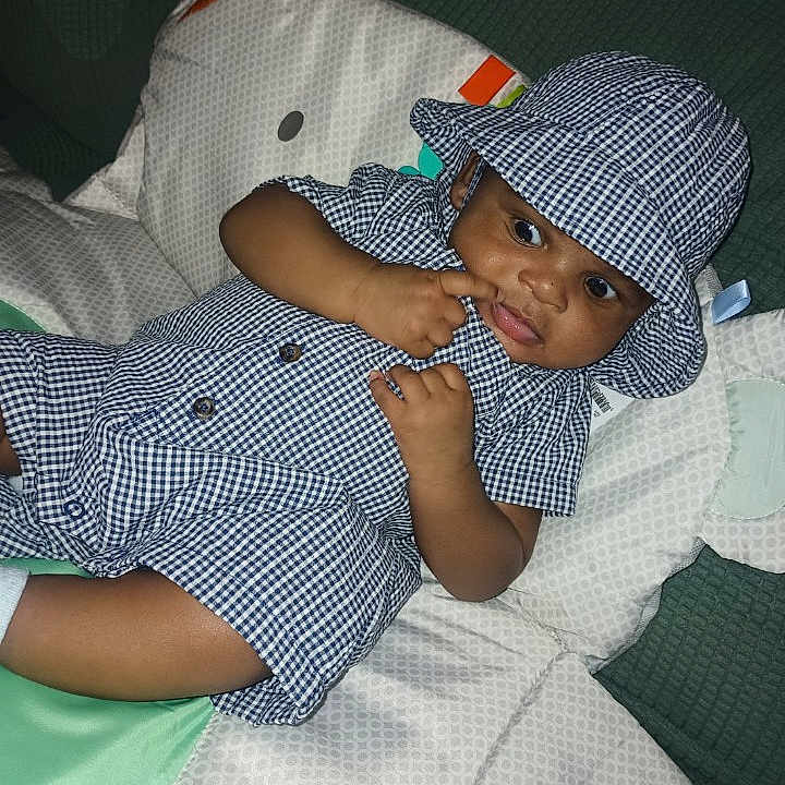 Gianni is registered to the contest to win money with this photo: accessories, baby, baseballcap, bed, bonnet, bracelet, cap, clothing, couch, cushion, dress, face, furniture, hat, head, homedecor, jewelry, person, photography, portrait