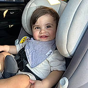 Carmelo is registered to the contest to win money with this photo: toddler, child, car_seat, smile, baby, seatbelt, clothing, person, face, indoor, car, sitting, happy, hair, head, light, window, seat, adult, safety