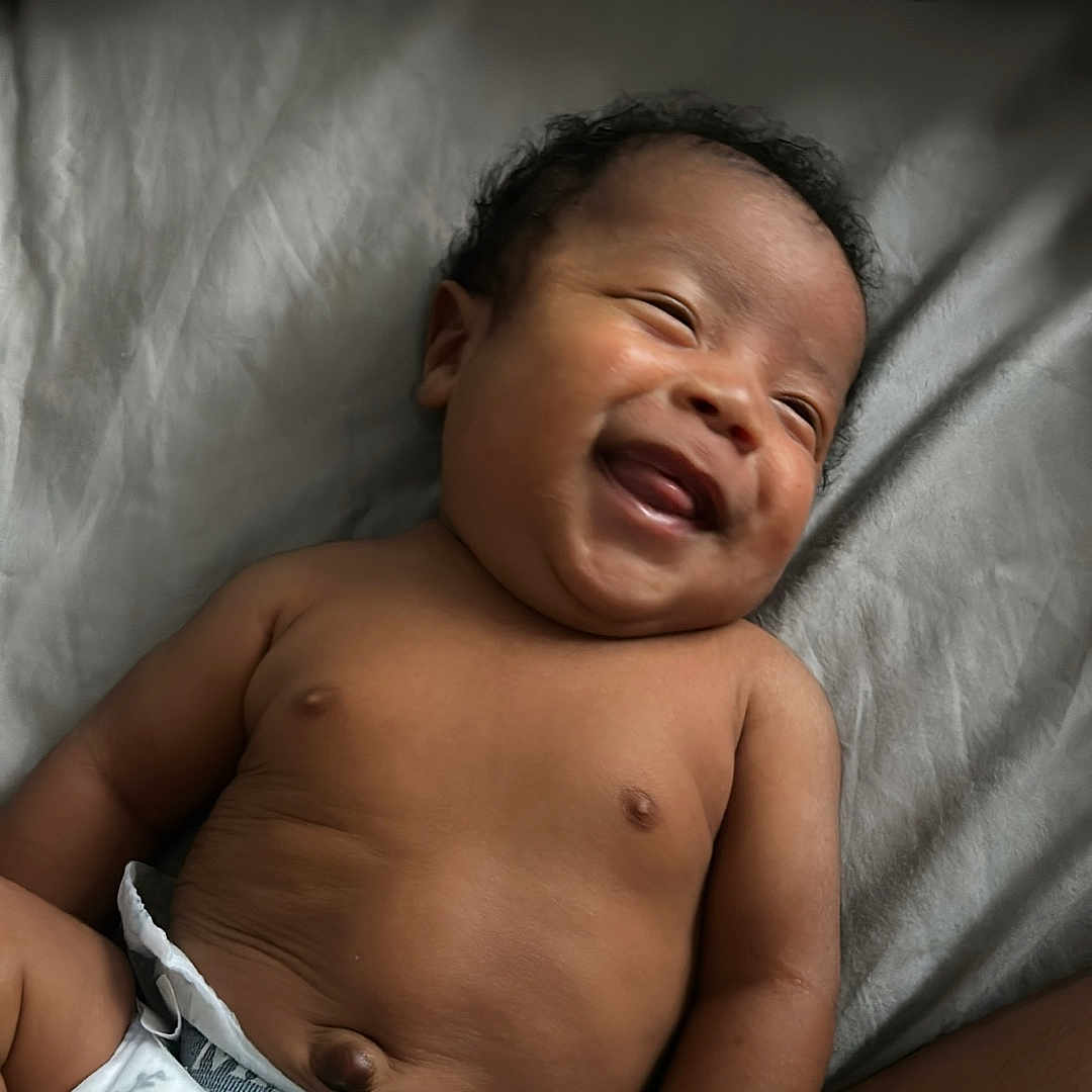 Coa is registered to the contest to win money with this photo: baby, blanket, child, chubby, comfort, cute, diaper, fleece_blanket, happy, home, indoors, infant, lying_down, person, portrait, relaxation, skin, sleepwear, smiling, young