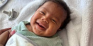 Coa joined the competition — help win amazing prizes! baby, smiling, blanket, pacifier, hand, towel, infant, cute, happy, clothing, striped_shirt, skin, face, lying_down, cozy, animal_print, soft_texture, newborn, portrait, indoors