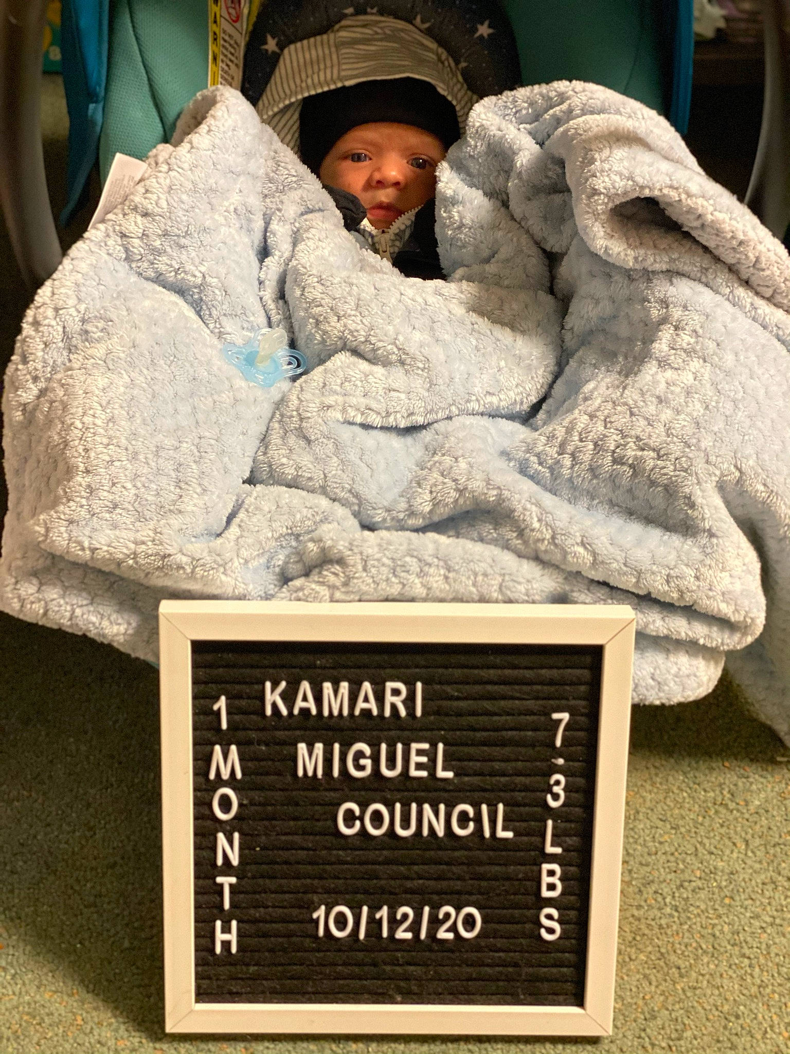 Kamari is registered to the contest to win money with this photo: art, baby, comfort, commemorative_plaque, font, fur, hat, headwear, linens, person, photo_caption, rock, room, sculpture, toddler