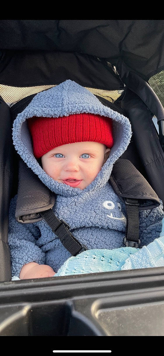 Tatem is registered to the contest to win money with this photo: baby, baby_carriage, baby_products, baby_toddler_clothing, cap, cheek, child, comfort, electric_blue, freezing, fun, headwear, jacket, knit_cap, organ, outerwear, people, person, product, snapshot