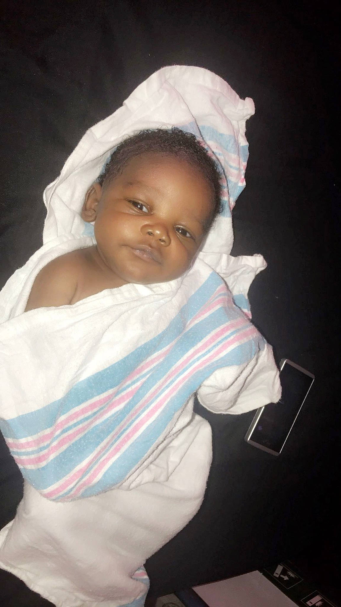 King is registered to the contest to win money with this photo: baby, cheek, child, face, head, headgear, linens, person, photography, skin, smile, textile, toddler, white