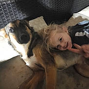 Eevee is registered to the contest to win money with this photo: blond_hair, child, couch, cozy, cuddling, dog, family, friendship, fur, head, indoor, laying_down, living_room, paw, person, pet, pillow, portrait, smile, snuggle