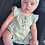 baby, child, infant, girl, headband, bow, blue_eyes, dress, sitting, car_seat, wooden_buttons, cute, innocent, soft_skin, natural_light, closeup, portrait, legs, feet, hand