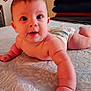 baby, infant, diaper, bed, blanket, skin, arm, face, eyes, mouth, cheeks, person, lying_down, curious, reaching, indoors, soft_light, texture, stacked_blankets, closeup