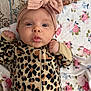 Emersyn is registered to the contest to win money with this photo: baby, infant, headband, bow, leopard_print, onesie, pout, face, skin, blanket, floral_pattern, cute, expression, lying_down, child, small_hands, indoors, soft_texture, cozy, adorable