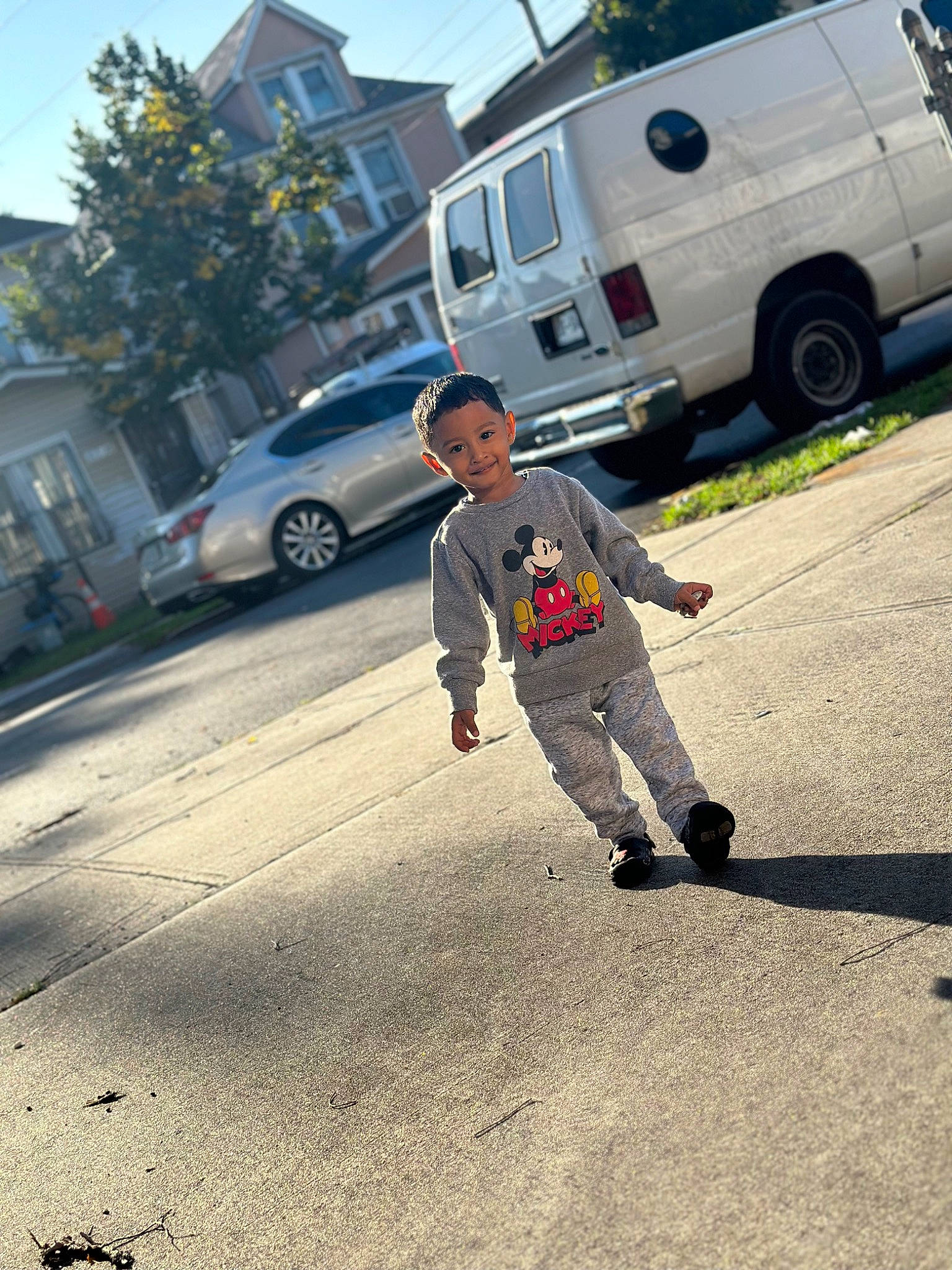 Austin is registered to the contest to win money with this photo: asphalt, automotive_exterior, automotive_tire, bumper, car, compact_van, joy, land_vehicle, light_commercial_vehicle, mode_of_transport, motor_vehicle, person, plant, road_surface, rolling, sidewalk, sky, tire, tree, vehicle