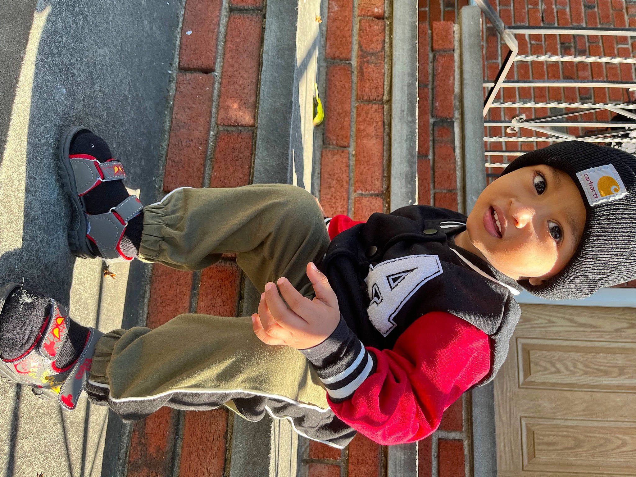 Austin is registered to the contest to win money with this photo: baseball_cap, brick, brickwork, cap, carmine, costume, eyewear, flooring, fun, happy, hat, headwear, human_leg, leisure, pattern, person, plaid, red, smile, street