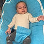 éline a rejoint le concours — aidez-le/la à gagner de superbes lots ! baby, sleeping, blue_cushion, infant, socks, long_sleeve_shirt, pants, indoor, furniture, table, trash_bin, cozy, peaceful, child, person, resting, home, casual, comfortable, cute
