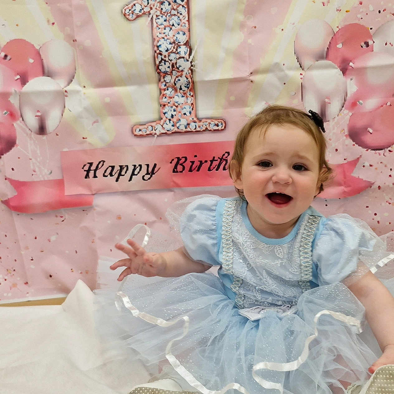 Imogen-Grace is registered to the contest to win money with this photo: baby, balloon, bodypart, clothing, dress, face, finger, flower, footwear, furniture, hand, happy, head, laughing, person, photography, plant, portrait, shoe, sitting