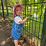 Amelia participe au concours pour gagner de l'argent avec cette photo : baby, barefoot, child, curious, daytime, denim_overalls, ducks, fence, grass, greenery, nature, outdoor, park, person, pink_hat, pond, summer, sunlight, toddler, trees
