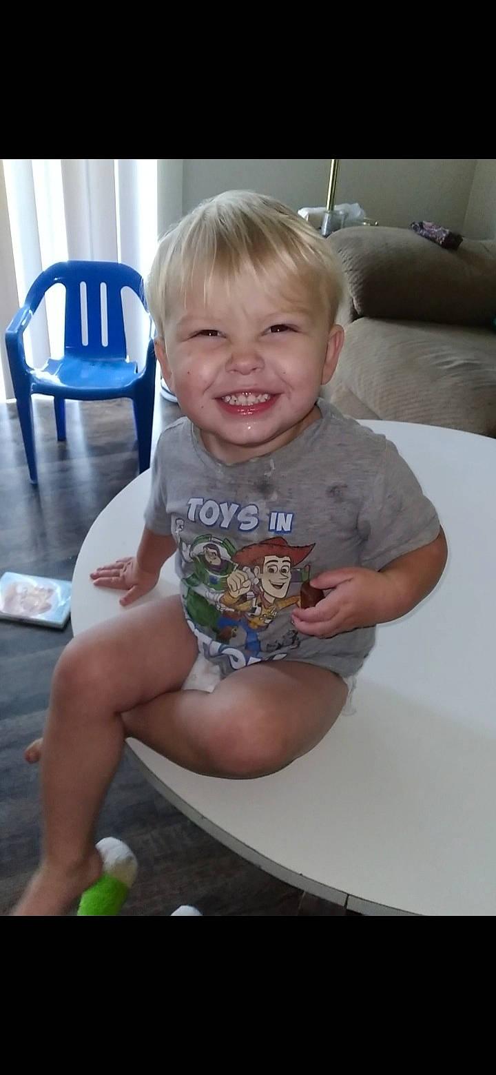 Keagan is registered to the contest to win money with this photo: baby, baby_toddler_clothing, cheek, face, facial_expression, finger, floor, hairstyle, head, human_body, joint, joy, knee, leg, mouth, person, shorts, shoulder, skin, smile