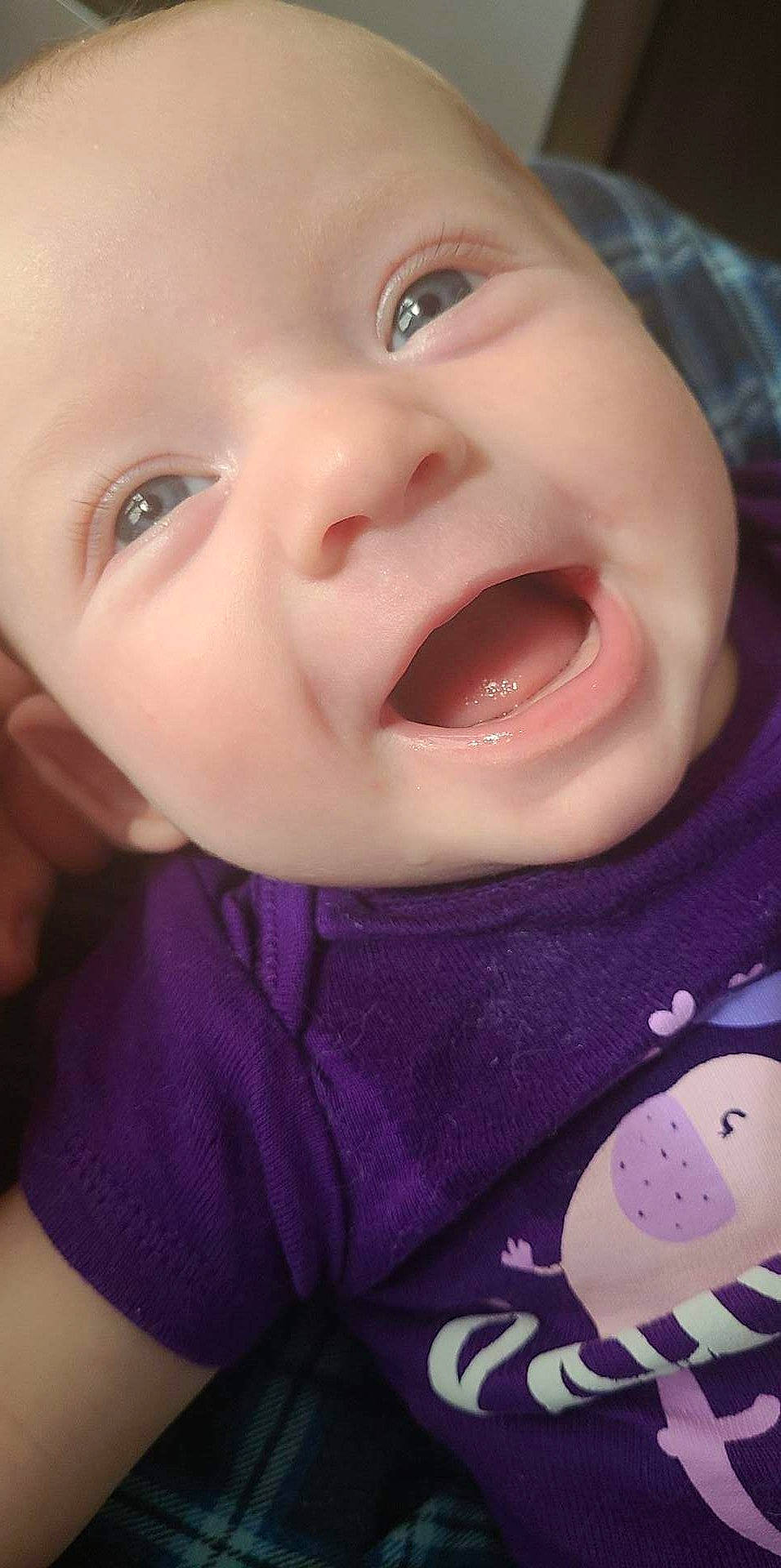 Iris is registered to the contest to win money with this photo: baby, cheek, chin, clothing, ear, eye, eyebrow, eyelash, forehead, iris, jaw, lip, mouth, neck, nose, person, skin, sleeve, smile, tongue