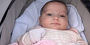 Mila joined the competition — help win amazing prizes! baby, infant, stroller, blanket, mittens, face, person, white_towel, cozy, pink, soft, cushion, clothing, newborn, portrait, resting, indoors, cute, child, sleepwear