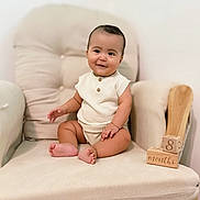 Matthias is registered to the contest to win money with this photo: baby, child, infant, sitting, chair, cushion, wooden_blocks, milestone, age, knit_clothing, smiling, indoors, comfortable, cute, portrait, happy, furniture, skin, feet, hand