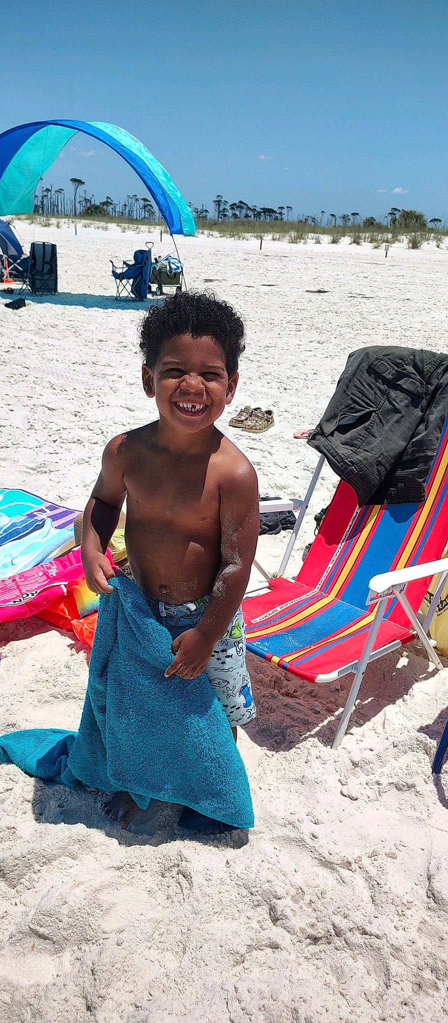 Kyrie joined the competition — help win amazing prizes! beach, blue, body_of_water, child, event, fun, happy, joy, landscape, leisure, people_in_nature, people_on_beach, person, recreation, sand, shade, sitting, sky, smile, summer