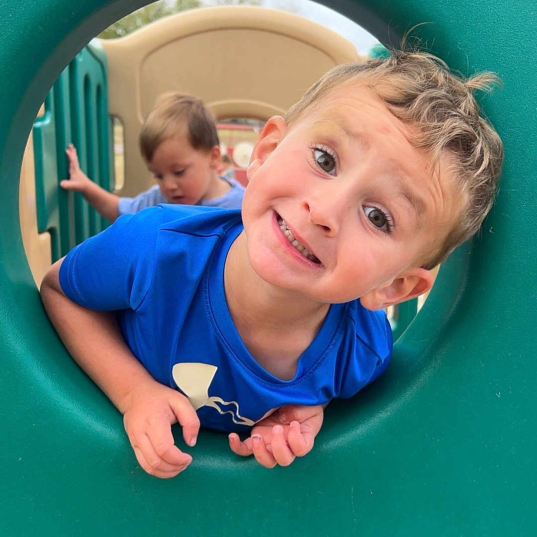 Logan joined the competition — help win amazing prizes! baby, bodypart, clothing, face, grass, head, indoors, mouth, outdoorplayarea, outdoors, person, photography, playarea, portrait, slide, summer, t_shirt, teeth, toy, window