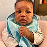 Kamiyah joined the competition — help win amazing prizes! baby, infant, child, portrait, face, eyes, serious_expression, curly_hair, bib, blue, blanket, clothing, sitting, indoors, bedroom, furniture, close_up, hands, cozy, photography