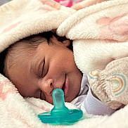 Amaya is registered to the contest to win money with this photo: newborn, baby, sleeping, pacifier, blanket, soft, plush, pastel_colors, cute, infant, peaceful, wrapped, cozy, face, closeup, child, person, resting, indoors, warm