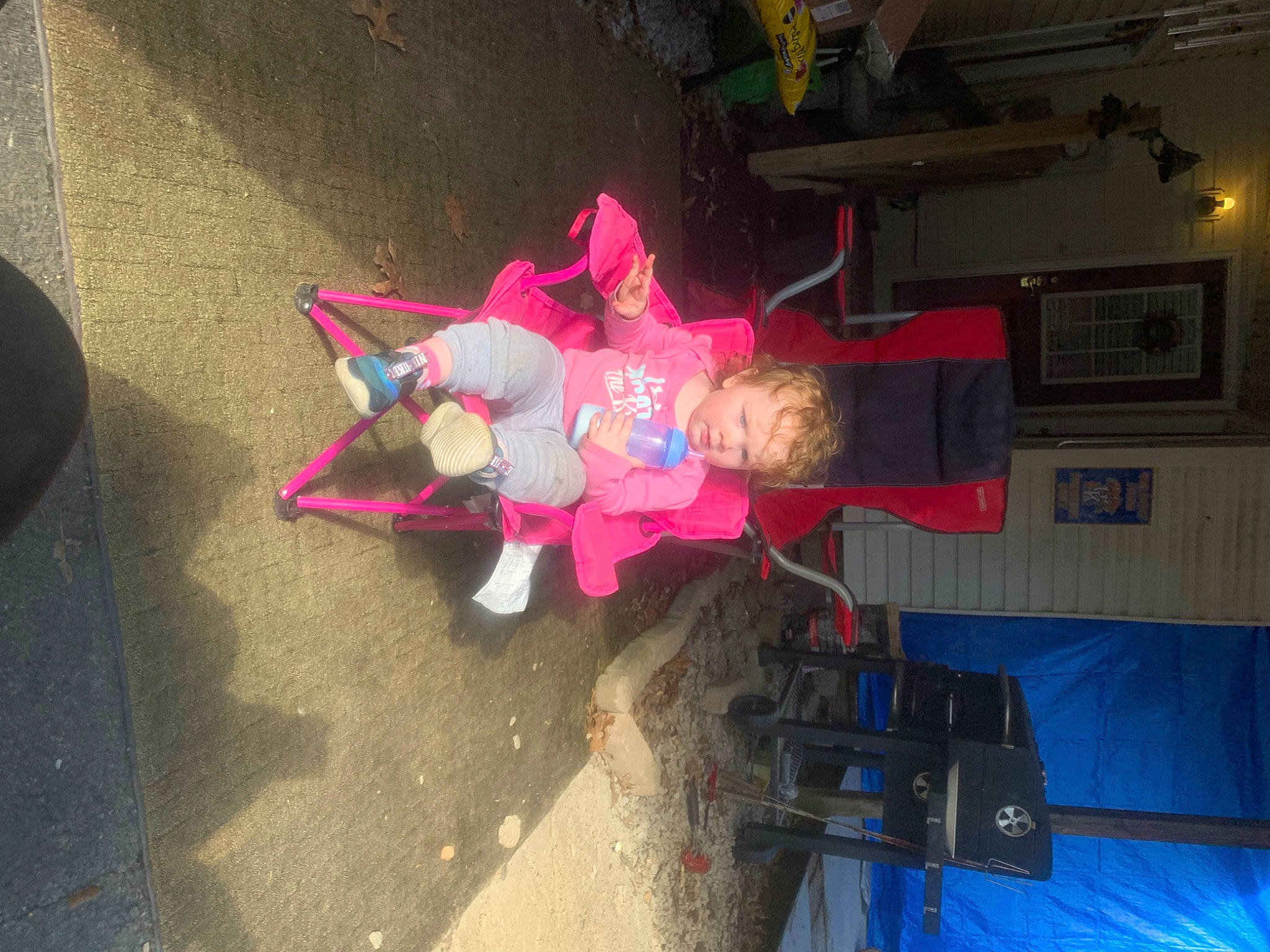 Emmerson is registered to the contest to win money with this photo: asphalt, carmine, event, fun, magenta, person, picture_frame, plant, room, stuffed_toy, tail, tire, toy, tree