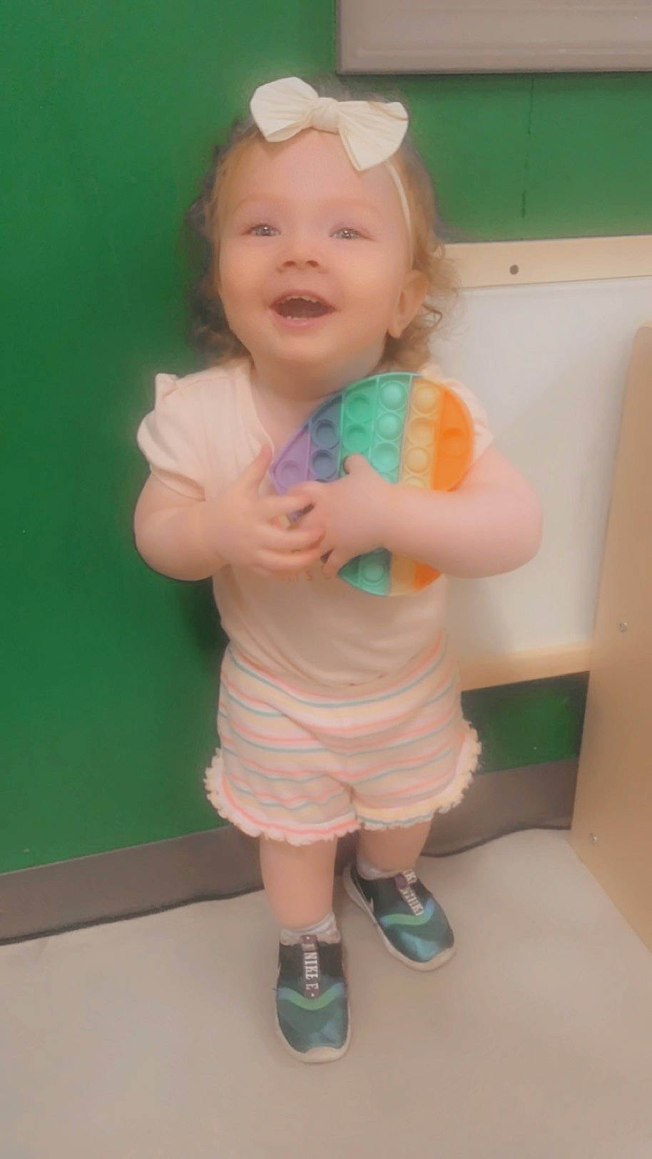 Emmerson joined the competition — help win amazing prizes! baby, baby_toddler_clothing, dress, face, finger, fun, gesture, goggles, happy, head, human_body, human_leg, leg, person, pink, shorts, skin, smile, standing, thumb