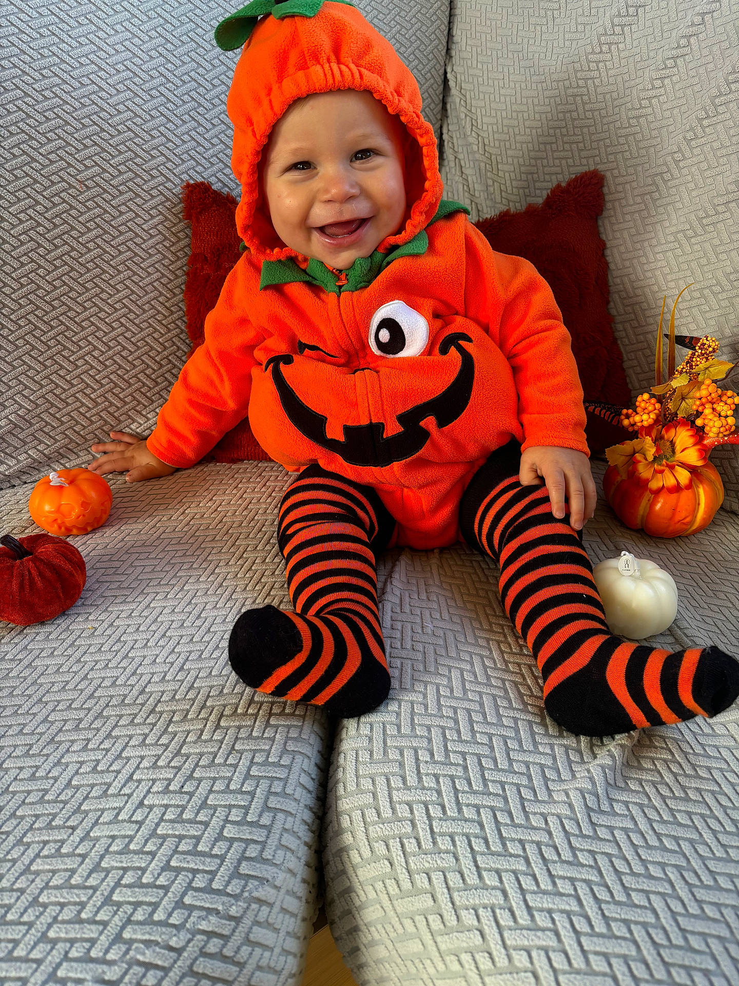 baby, bodypart, clothing, coat, face, finger, food, hand, hat, head, hosiery, person, photography, plant, portrait, produce, pumpkin, sock, squash, vegetable