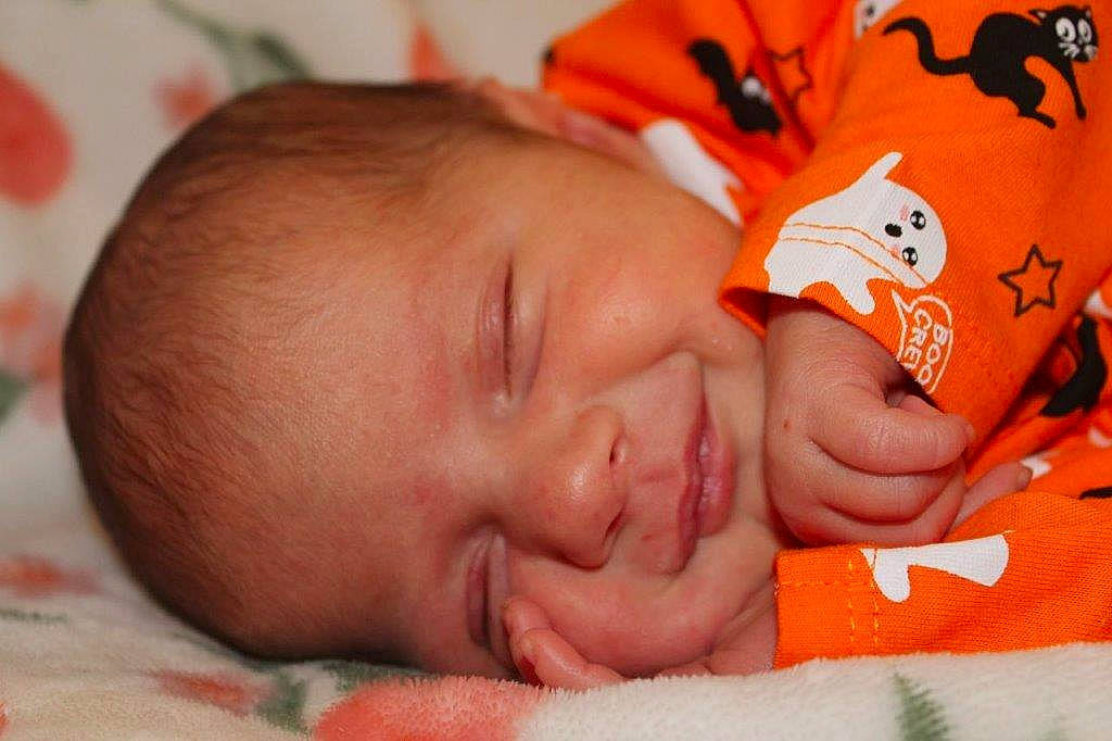 Cecilia is registered to the contest to win money with this photo: baby, cheek, child, chin, close_up, comfort, eyebrow, face, facial_expression, finger, fun, hair, happy, head, mouth, nose, orange, person, skin, smile