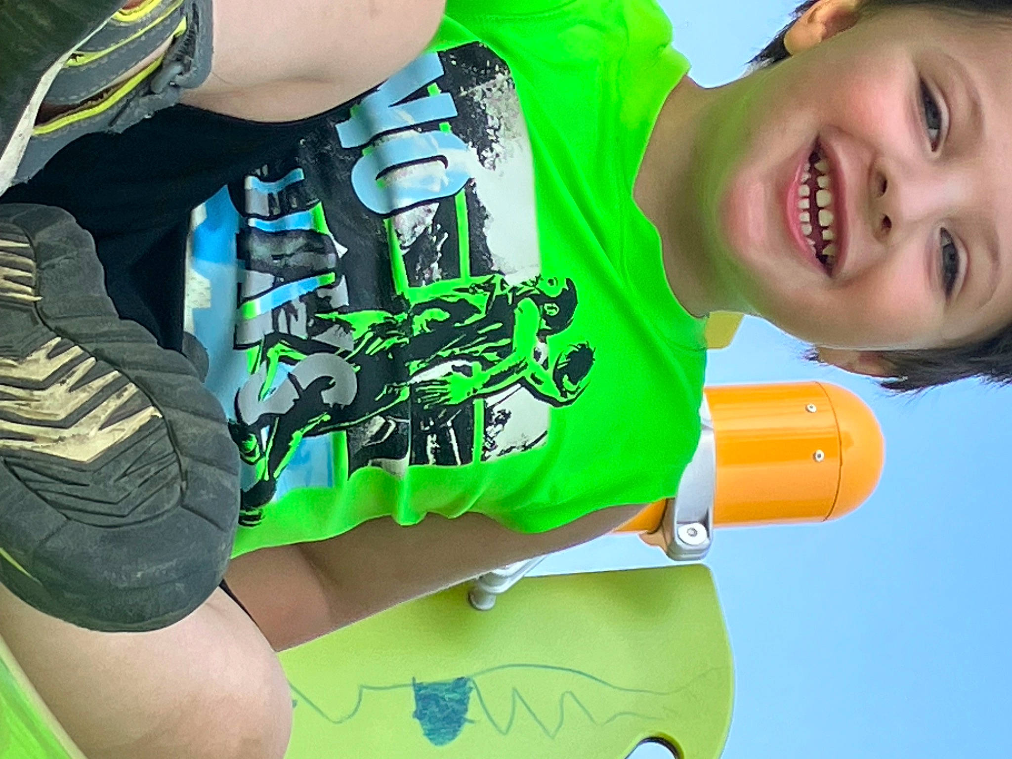 Xander is registered to the contest to win money with this photo: arm, cool, elbow, electric_blue, finger, font, gesture, green, happy, headwear, human_body, joy, leisure, light, person, personal_protective_equipment, shorts, sleeve, smile, sportswear