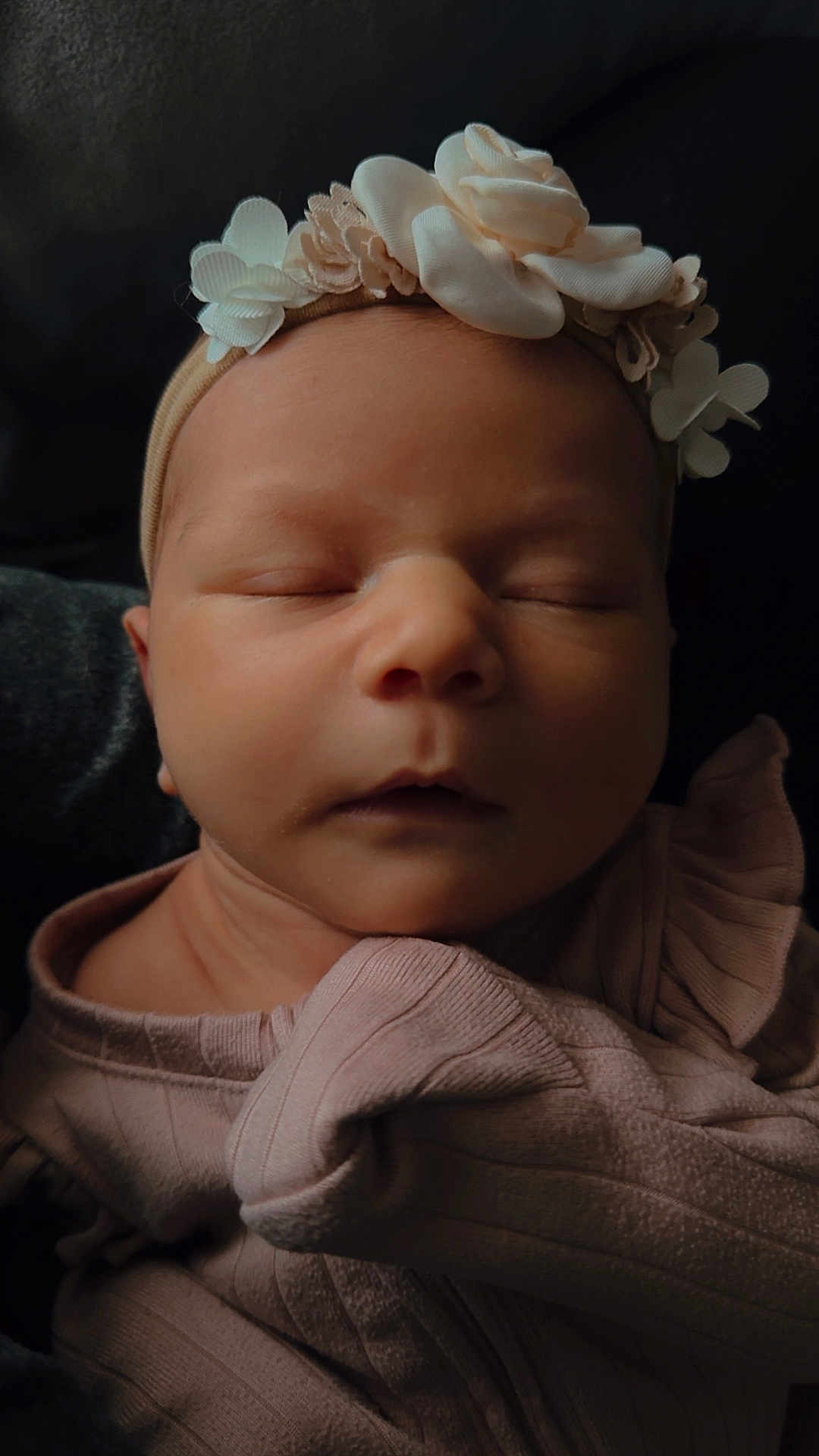 Milana joined the competition — help win amazing prizes! baby, newborn, infant, sleeping, headband, flower_headband, flowers, closed_eyes, portrait, close_up, soft_lighting, pink_clothing, swaddle, cozy, peaceful, skin, face, cheeks, nose, ruffle