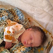 Evangeline is registered to the contest to win money with this photo: baby, sleeping, blanket, pajamas, cozy, soft, knitted_blanket, infant, resting, hand, comfort, warm, bed, toddler, child, cute, peaceful, indoors, person, portrait