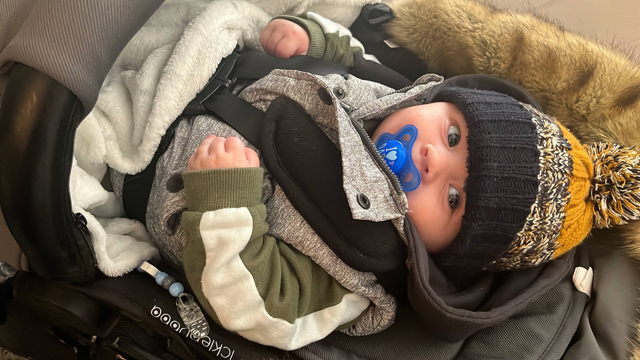 Jaxon is registered to the contest to win money with this photo: baby, baby_products, beanie, cheek, child, comfort, fashion_accessory, fur, headwear, knit_cap, linens, nap, pattern, person, portrait_photography, sitting, sleep, textile, toddler, winter