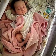 Scarlett is registered to the contest to win money with this photo: baby, sleeping, blanket, crib, infant, pink, soft, cozy, cute, child, resting, cute_baby, peaceful, toddler, clothing, foot, hand, face, animal_print, nursery