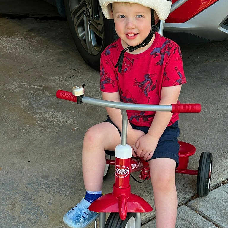 Grayson joined the competition — help win amazing prizes! boy, car, child, clothing, face, footwear, hardhat, head, helmet, machine, male, person, photography, portrait, shoe, shorts, transportation, tricycle, vehicle, wheel