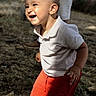 Augustin participe au concours pour gagner de l'argent avec cette photo : casual_clothing, child, cute, daylight, grass, happy, joyful, nature, outdoor, person, playful, red_shorts, sandals, shadow, smiling, summer, sunlight, toddler, white_polo_shirt, young_child