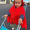 Augustin participe au concours pour gagner de l'argent avec cette photo : asphalt, cape, casual, child, clothing, concentration, daylight, fun, hooded_cape, outdoor, people, play, red_hood, road, street, stroller, toddler, toy, walking, young_child