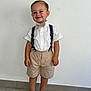 Giuliann a rejoint le concours — aidez-le/la à gagner de superbes lots ! child, boy, smile, barefoot, shorts, suspenders, bow_tie, white_shirt, standing, tile_floor, indoor, casual, cute, happy, portrait, fashion, person, minimalist_background, light, clothing