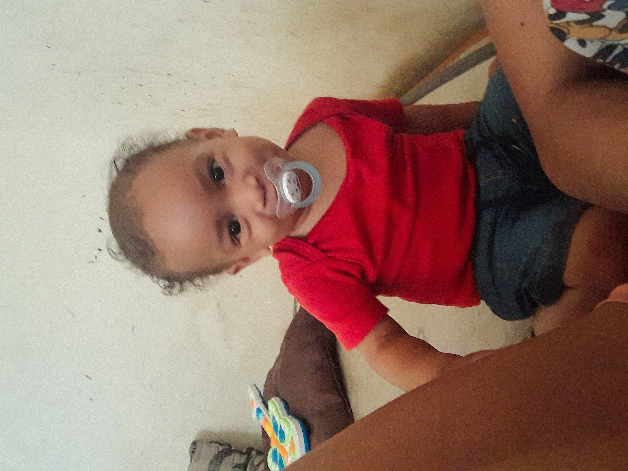 Nolan participe au concours pour gagner de l'argent avec cette photo : cheek, elbow, eye, face, floor, flooring, fun, happy, head, joint, leg, mouth, neck, nose, person, skin, smile, thigh, toddler, trunk