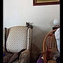 kitten, cat, armchair, furniture, painting, tiger, wall, cushion, living_room, domestic, resting, small_animal, indoor, patterned_fabric, wooden_chair, decor, household, quiet, relaxation, cozy