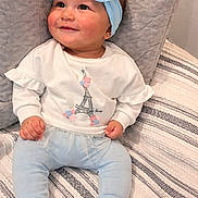 Amahia Zoe is registered to the contest to win money with this photo: baby, child, smiling, headband, blue_bow, white_top, leggings, sitting, cushion, blanket, striped_blanket, indoor, cute, happy, portrait, infant, fashion, cozy, homedecor, toddler