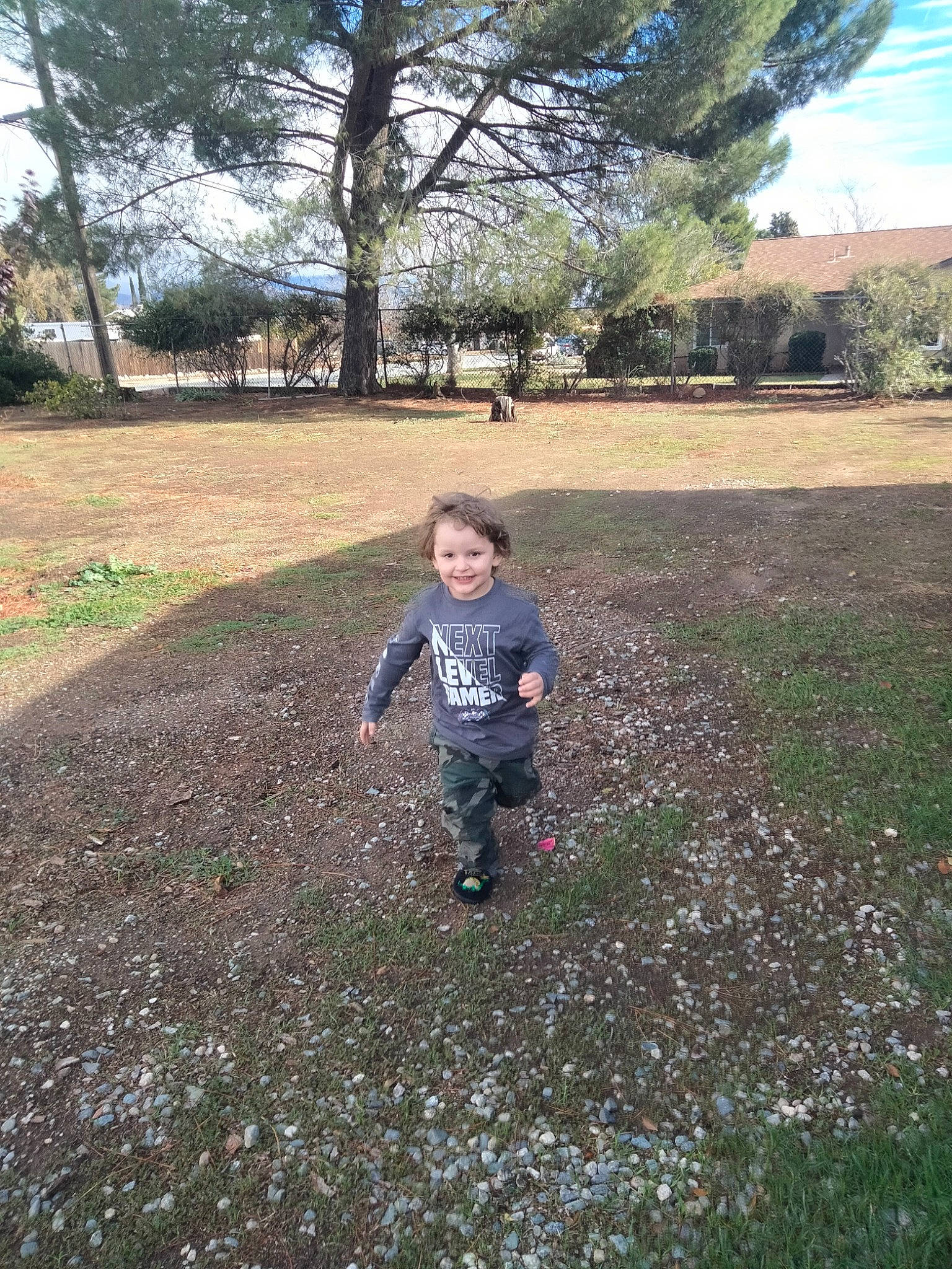 Troy is registered to the contest to win money with this photo: asphalt, fun, grass, grass_family, grassland, joy, landscape, lawn, leisure, people_in_nature, person, plant, recreation, road_surface, running, sky, soil, toddler, tree, walking