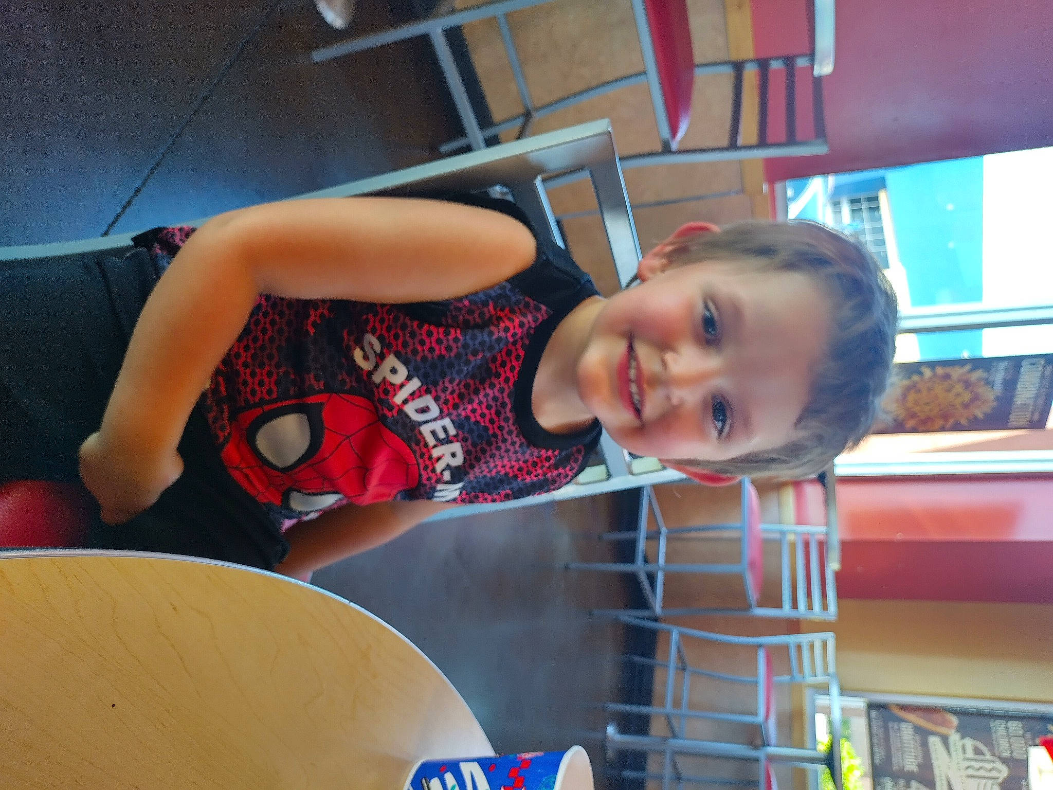 Troy is registered to the contest to win money with this photo: child, elbow, fun, happy, human_leg, joy, leisure, pattern, person, play, recreation, room, sitting, smile, t_shirt, thigh, toddler, vacation